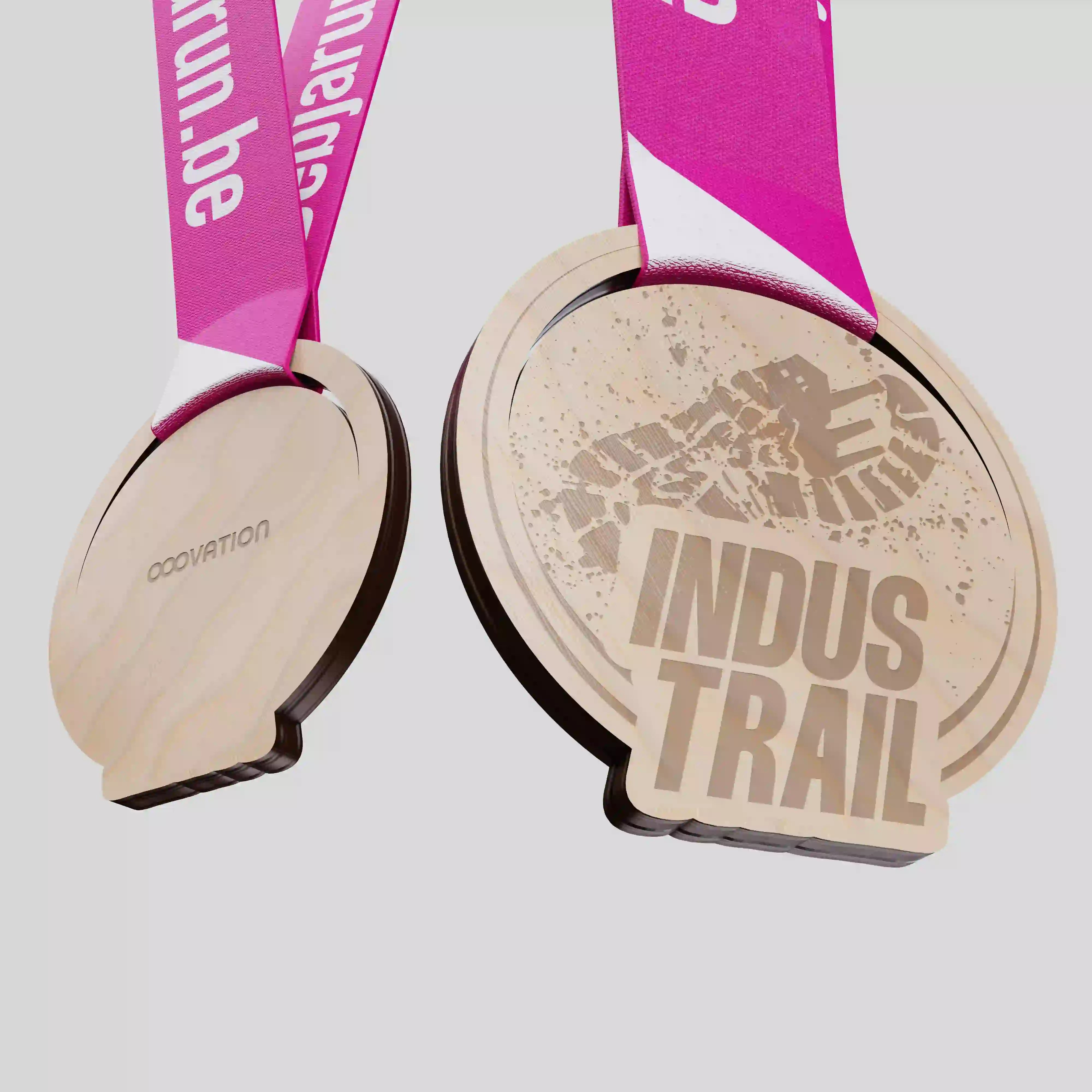 Custom wood medal for the Indus Trail event featuring engraved footprint texture and OOOVATION back