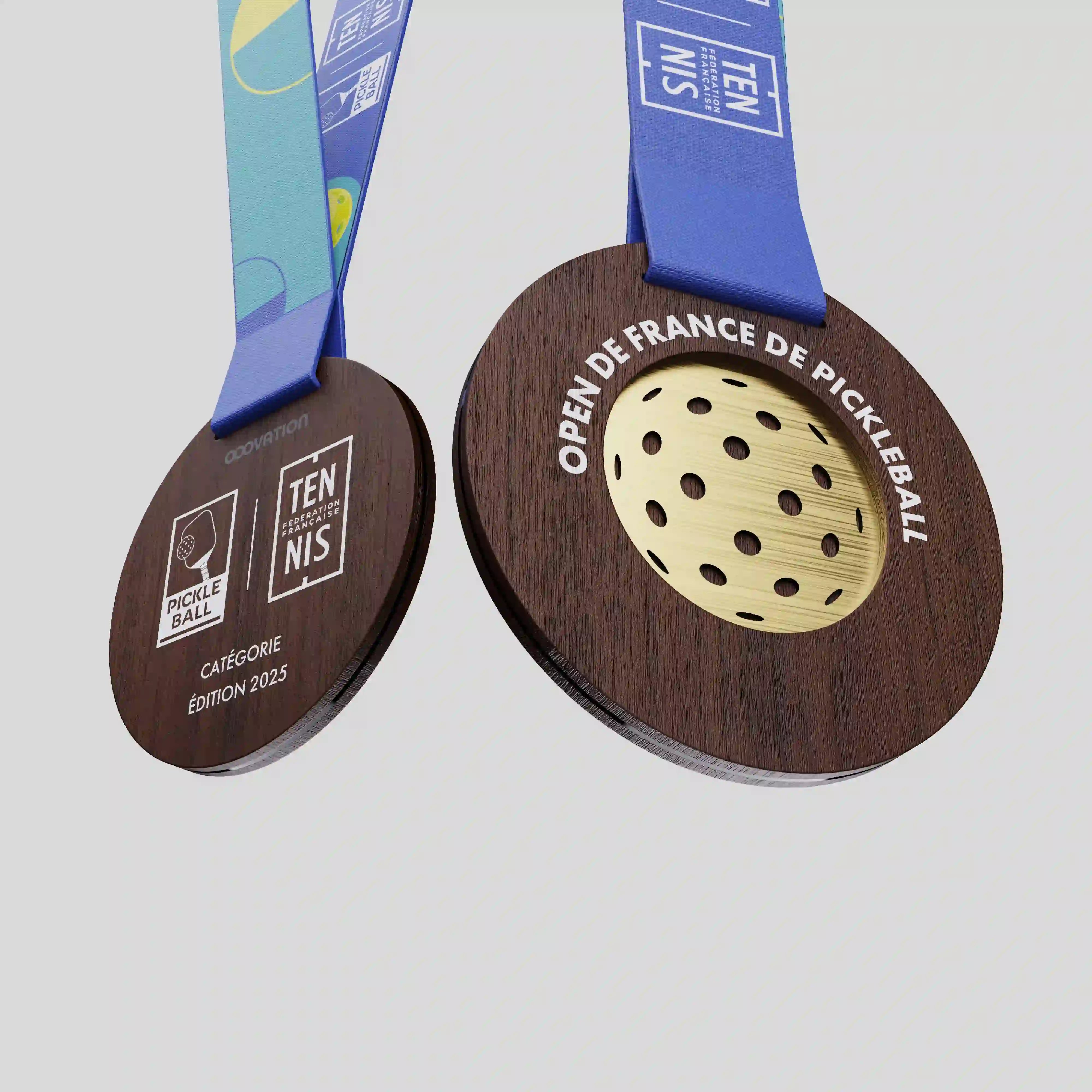 Close-up of the French Open of Pickleball wooden medal showing engraved text and golden pickleball-style insert.
