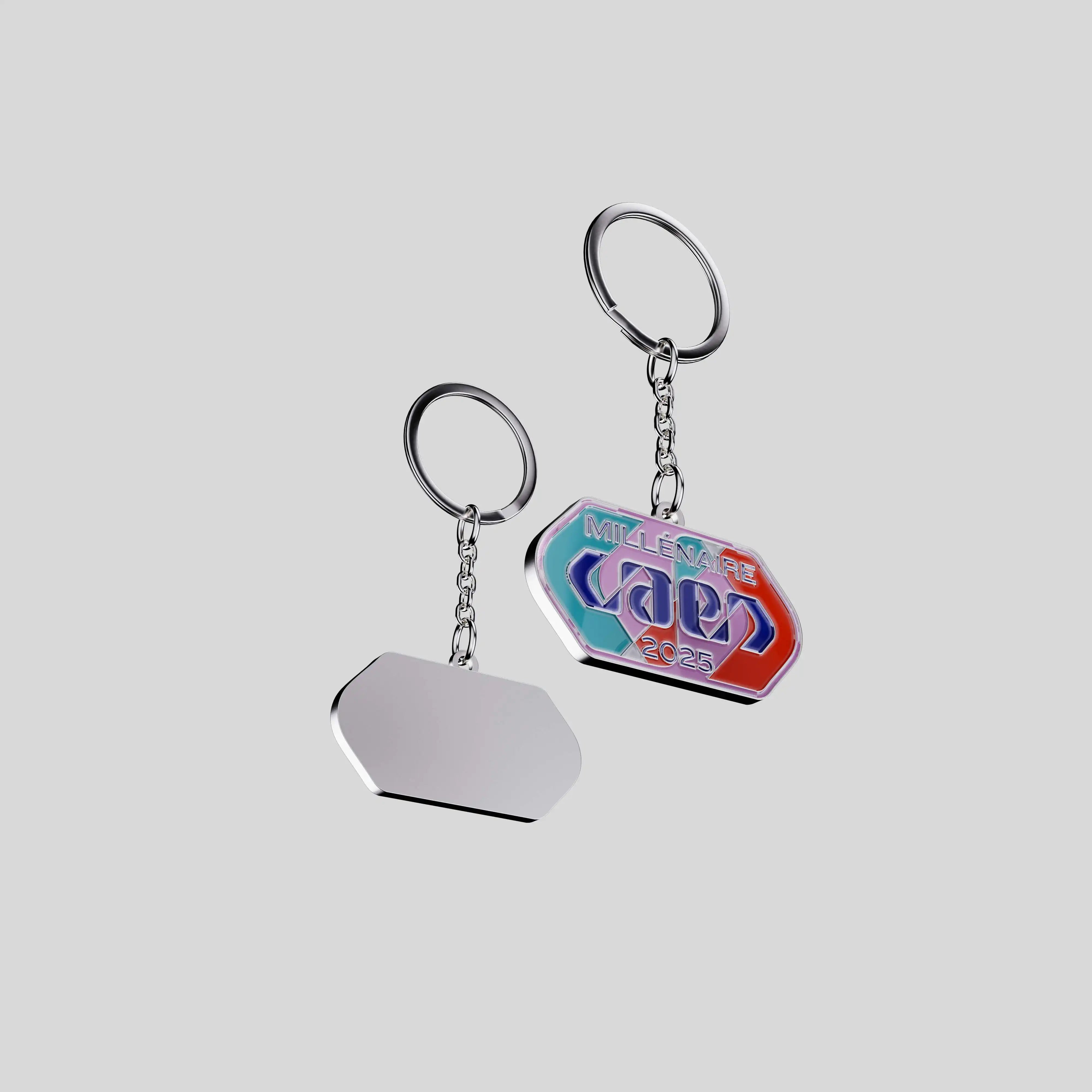 Front and back of the City of Caen 2025 keychain showing metal base and enamel finish.